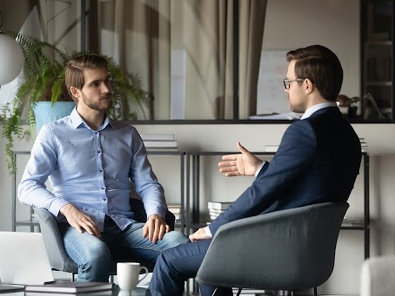 An advisor in conversation with an executive